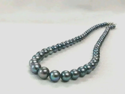 Akoya pearl necklace with blue dyed round pearls sized 9.1-6 mm on a 43.5 cm string with visible luster