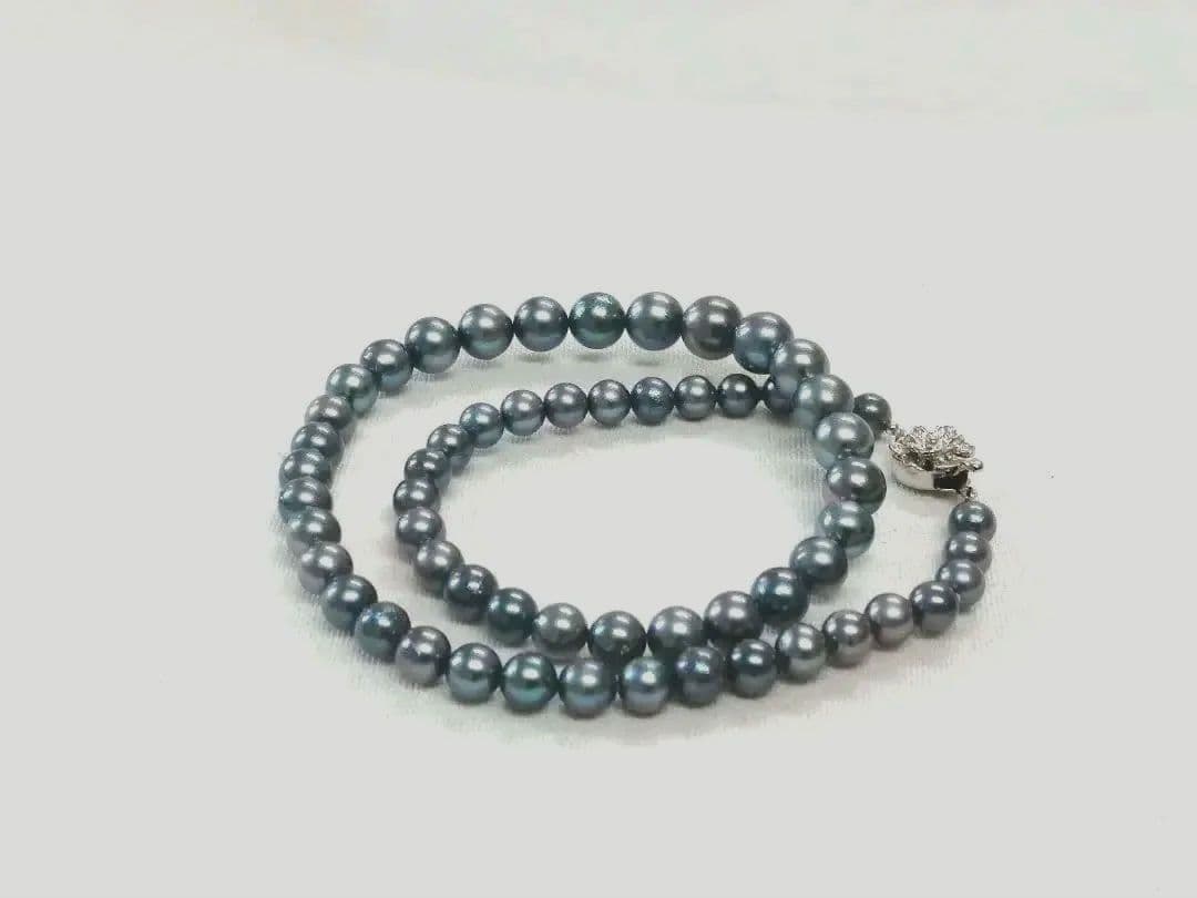Akoya pearl necklace with blue dyed round pearls sized 9.1-6 mm on a 43.5 cm string with visible luster