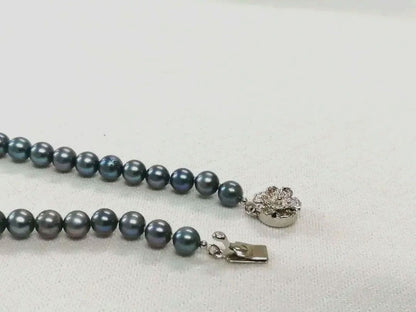 Akoya pearl necklace with blue dyed round pearls sized 9.1-6 mm on a 43.5 cm string with visible luster