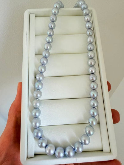 Akoya pearl necklace with 7-8mm ice blue gray semi-baroque pearls showing natural growth marks and gentle shine