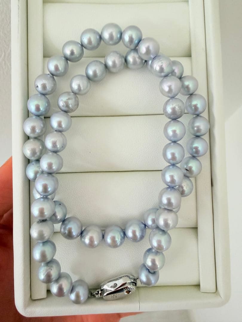 Akoya pearl necklace with 7-8mm ice blue gray semi-baroque pearls showing natural growth marks and gentle shine