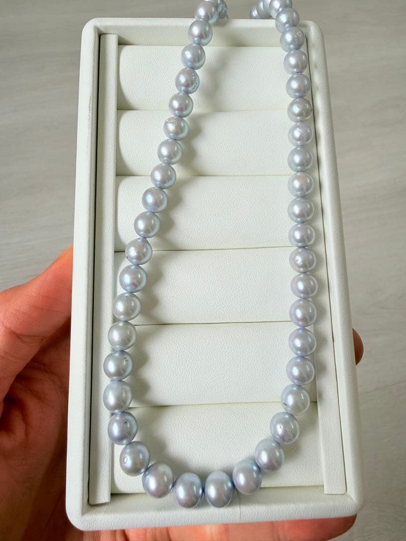 Akoya pearl necklace with 7-8mm ice blue gray semi-baroque pearls showing natural growth marks and gentle shine
