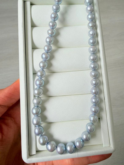 Akoya pearl necklace with 7-8mm ice blue gray semi-baroque pearls showing natural growth marks and gentle shine