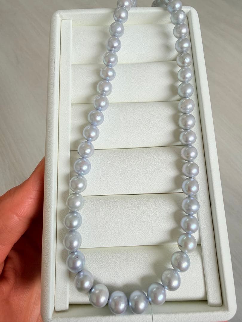 Akoya pearl necklace with 7-8mm ice blue gray semi-baroque pearls showing natural growth marks and gentle shine