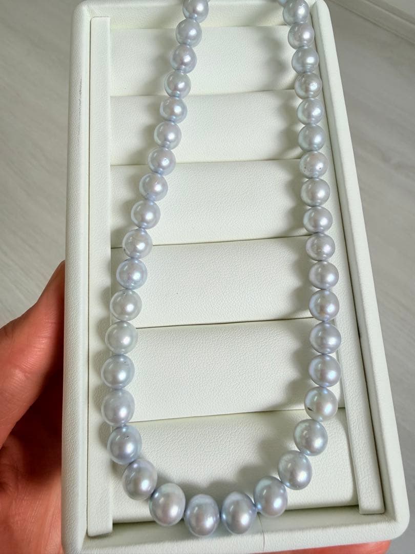 Akoya pearl necklace with 7-8mm ice blue gray semi-baroque pearls showing natural growth marks and gentle shine