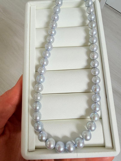 Akoya pearl necklace with 7-8mm ice blue gray semi-baroque pearls showing natural growth marks and gentle shine