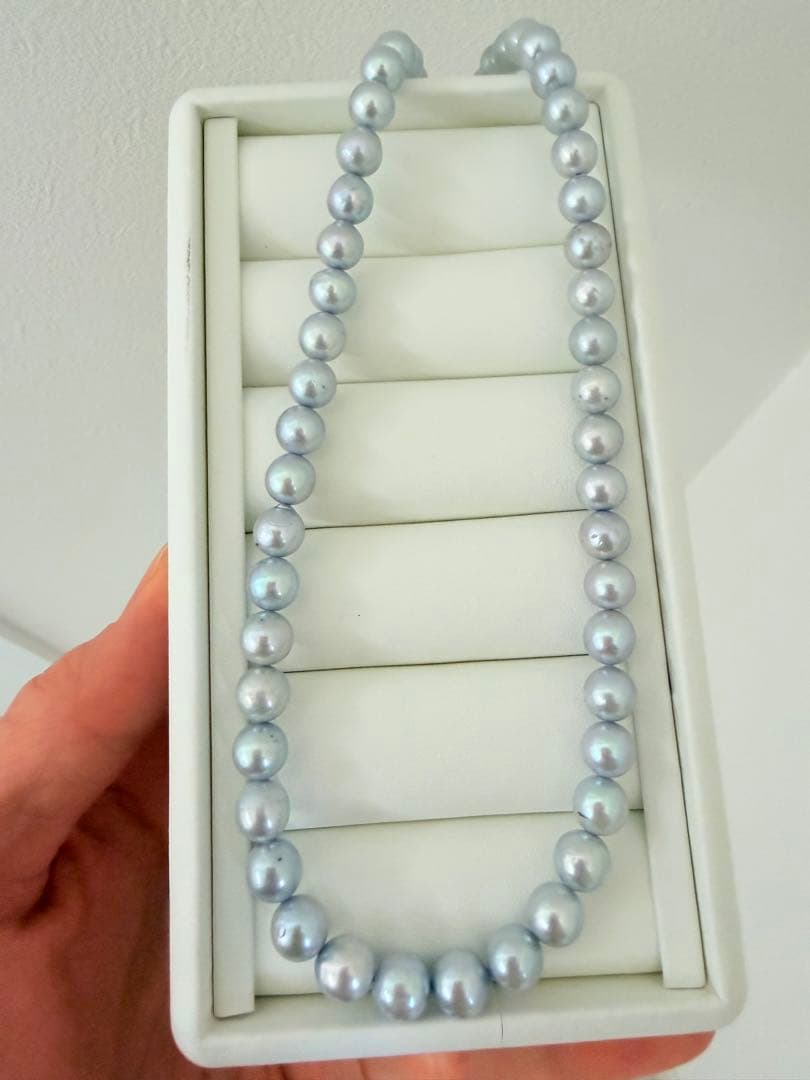 Akoya pearl necklace with 7-8mm ice blue gray semi-baroque pearls showing natural growth marks and gentle shine