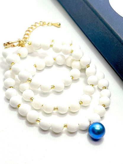 Akoya pearl necklace with black and indigo blue pearls, white onyx beads, and K18 gold leaf Venetian glass parts