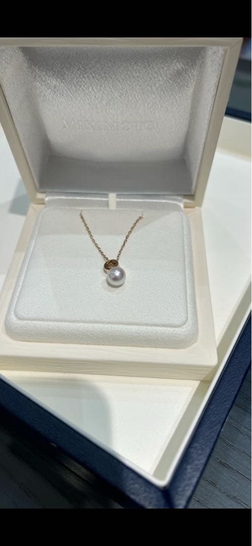 Mikimoto pink gold chain necklace with a single pearl pendant on white background