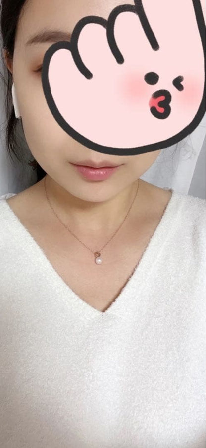 Mikimoto pink gold chain necklace with a single pearl pendant on white background