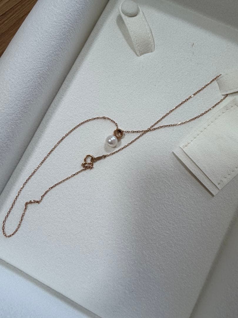 Mikimoto pink gold chain necklace with a single pearl pendant on white background