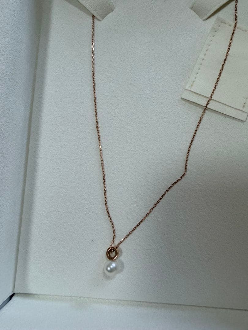 Mikimoto pink gold chain necklace with a single pearl pendant on white background