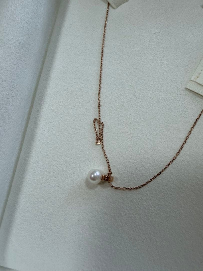 Mikimoto pink gold chain necklace with a single pearl pendant on white background