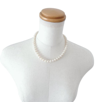 Close-up of an Akoya pearl necklace featuring 8-8.5mm white pearls on a 40cm strand