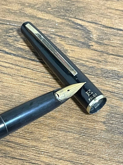 Pilot Fountain Pen E in black with gold trim featuring a soft inset nib