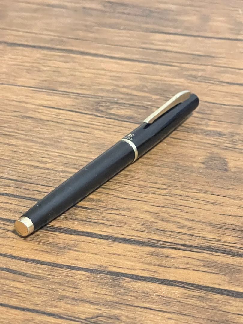 Pilot Fountain Pen E in black with gold trim featuring a soft inset nib