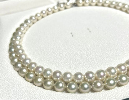 Akoya pearl necklace with 8mm blue-gray beads, silicone cushions, and silver clasp with five blue stones