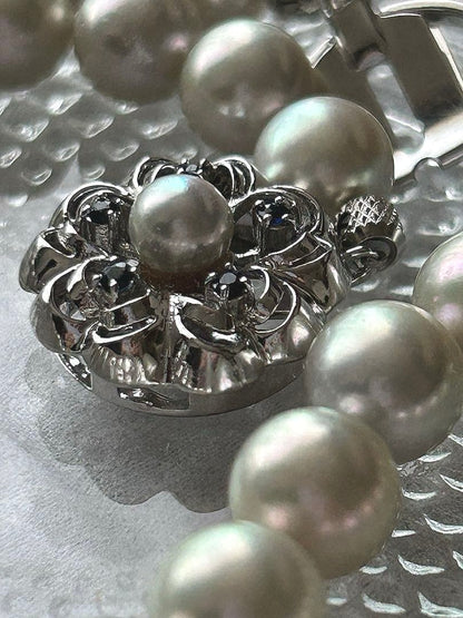 Akoya pearl necklace with 8mm blue-gray beads, silicone cushions, and silver clasp with five blue stones