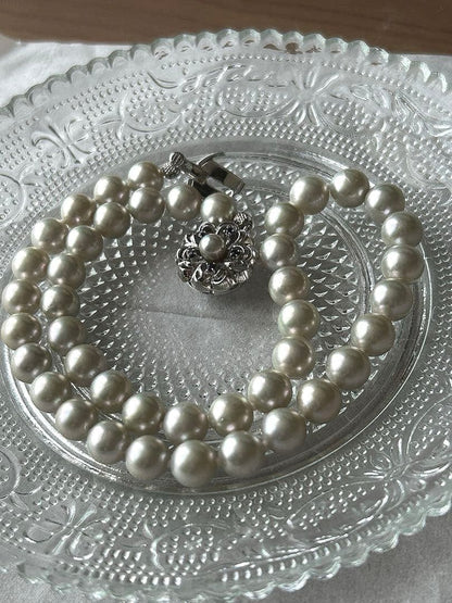 Akoya pearl necklace with 8mm blue-gray beads, silicone cushions, and silver clasp with five blue stones