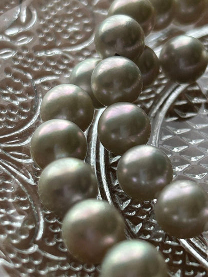 Akoya pearl necklace with 8mm blue-gray beads, silicone cushions, and silver clasp with five blue stones