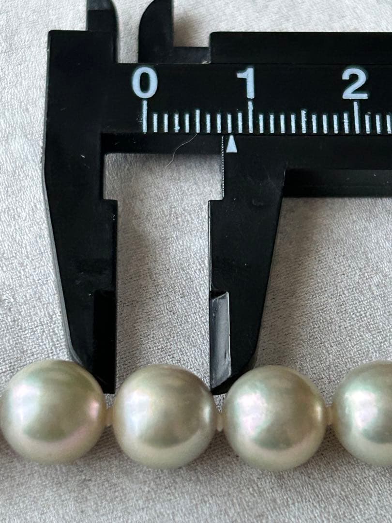 Akoya pearl necklace with 8mm blue-gray beads, silicone cushions, and silver clasp with five blue stones
