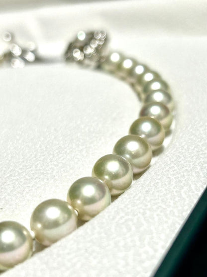 Akoya pearl necklace with 8mm blue-gray beads, silicone cushions, and silver clasp with five blue stones