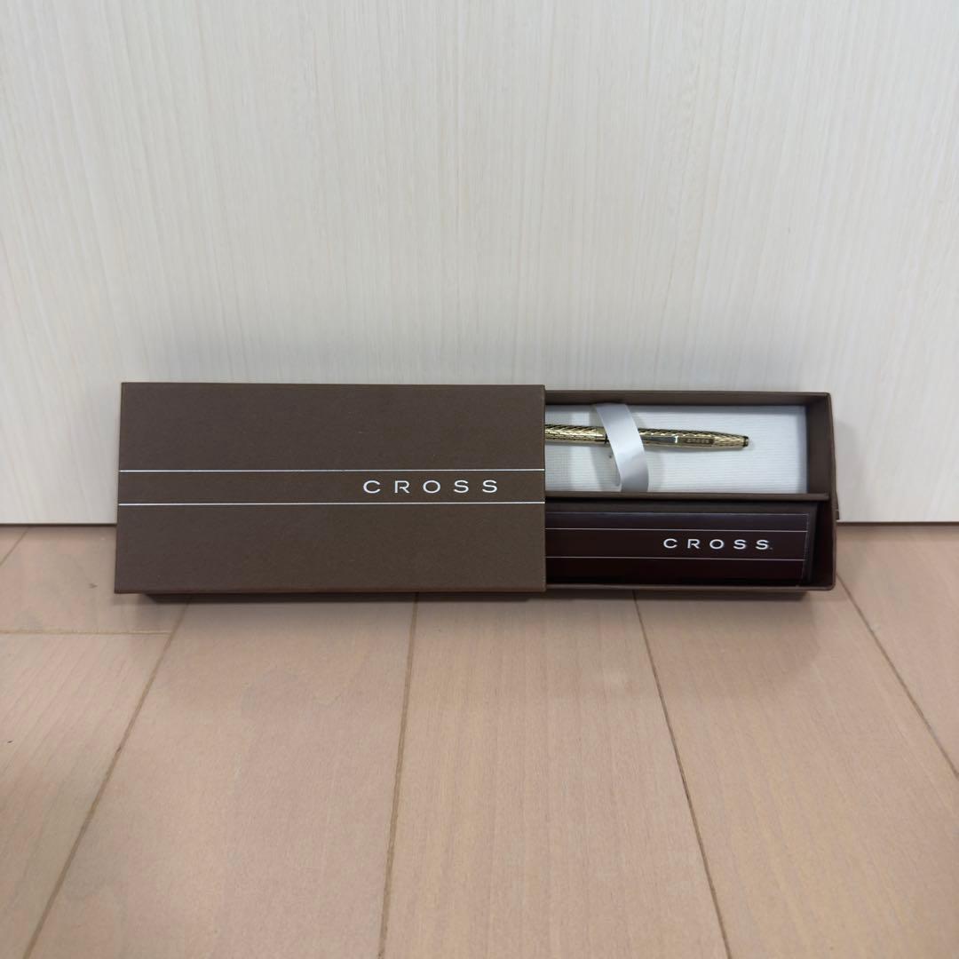 Gold CROSS ballpoint pen with diamond cut design displayed alongside original box