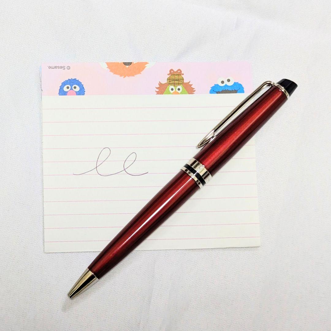 Waterman Expert dark red metal ballpoint pen with twist design alongside dedicated case