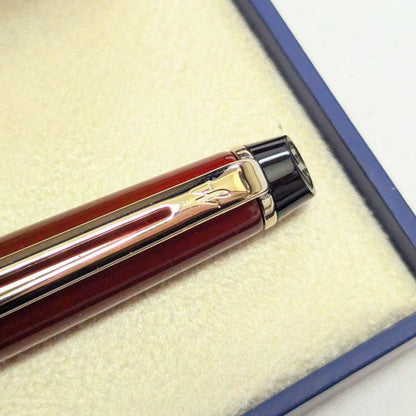 Waterman Expert dark red metal ballpoint pen with twist design alongside dedicated case