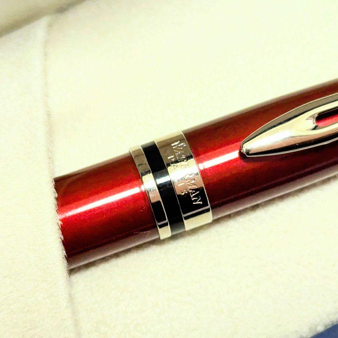 Waterman Expert dark red metal ballpoint pen with twist design alongside dedicated case