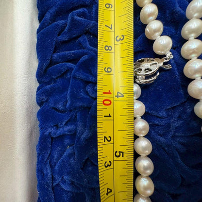 Oyster pearl necklace featuring 8mm white Akoya pearls strung on a classic design