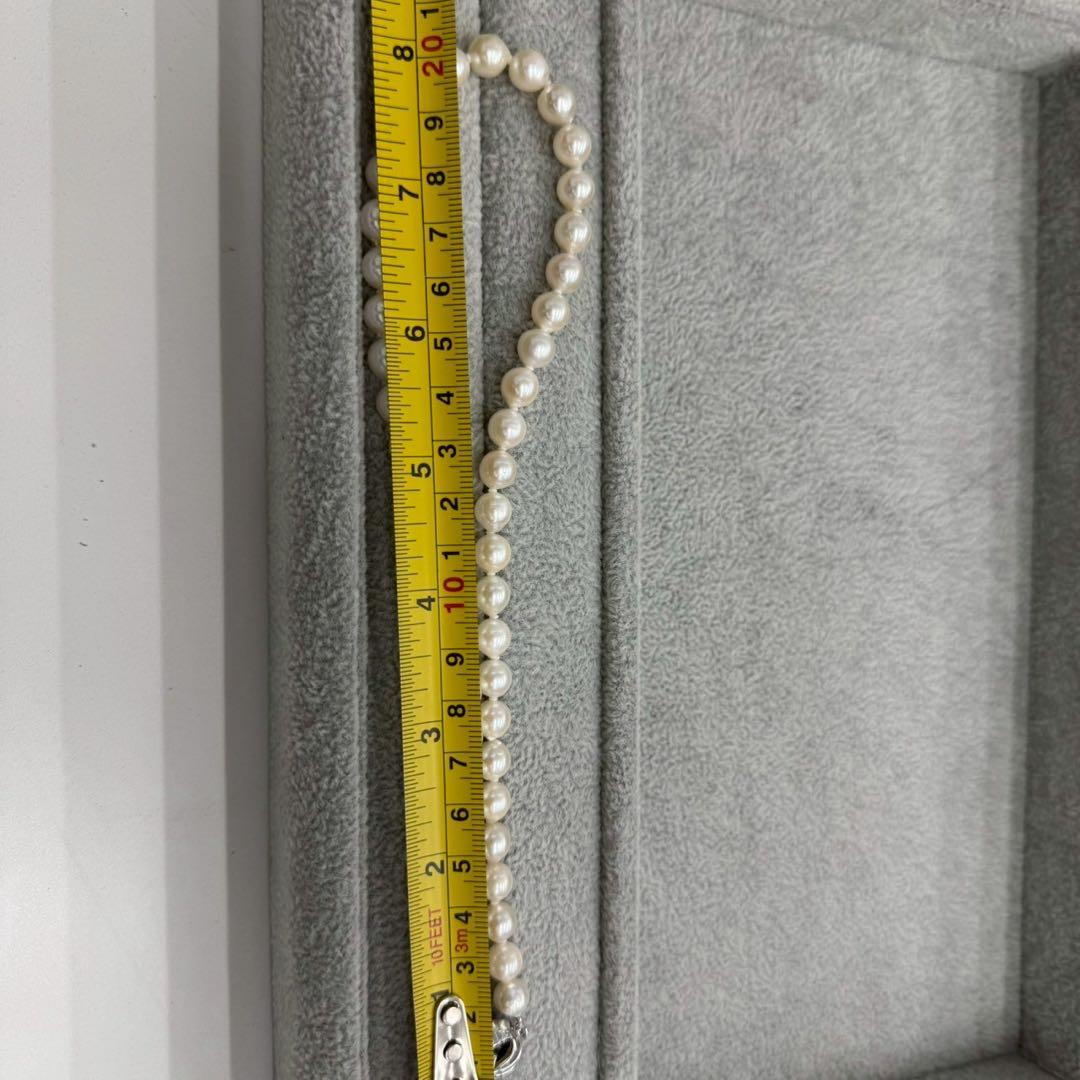 Oyster pearl necklace featuring 8mm white Akoya pearls strung on a classic design