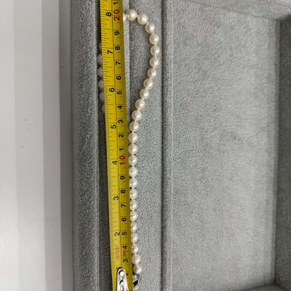 Oyster pearl necklace featuring 8mm white Akoya pearls strung on a classic design
