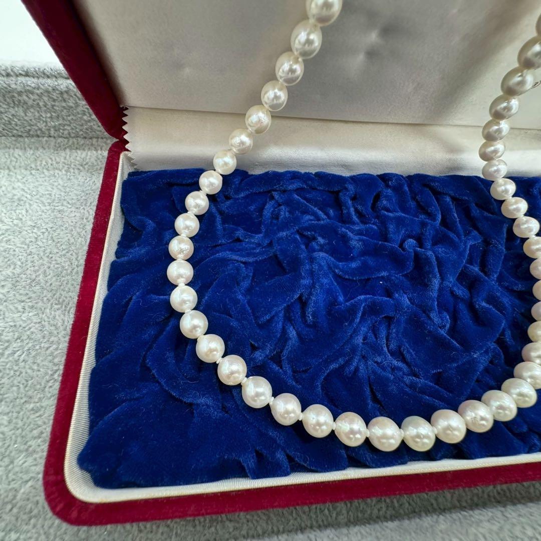 Oyster pearl necklace featuring 8mm white Akoya pearls strung on a classic design