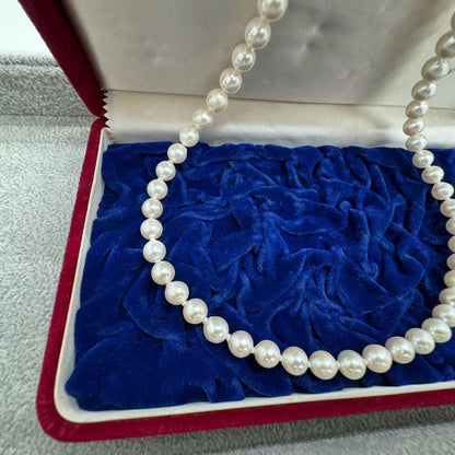 Oyster pearl necklace featuring 8mm white Akoya pearls strung on a classic design