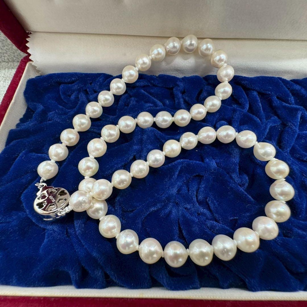 Oyster pearl necklace featuring 8mm white Akoya pearls strung on a classic design