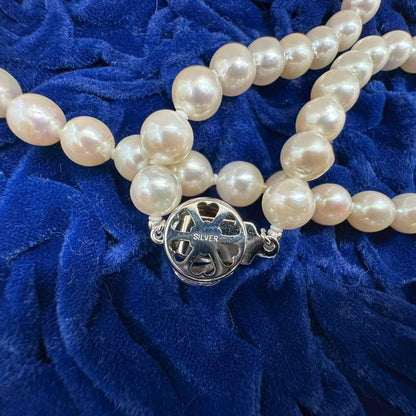 Oyster pearl necklace featuring 8mm white Akoya pearls strung on a classic design