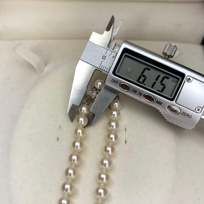 LongAkoya 96cm 2 strand necklace featuring 6.5mm round white Akoya pearls with silver marking