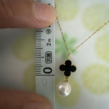 K18YG necklace with white Akoya pearls and onyx flower pendant on a 45 cm chain