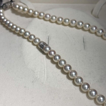 Mikimoto Akoya pearl necklace with 7.0-7.5mm pearls and silver clasp on a white background