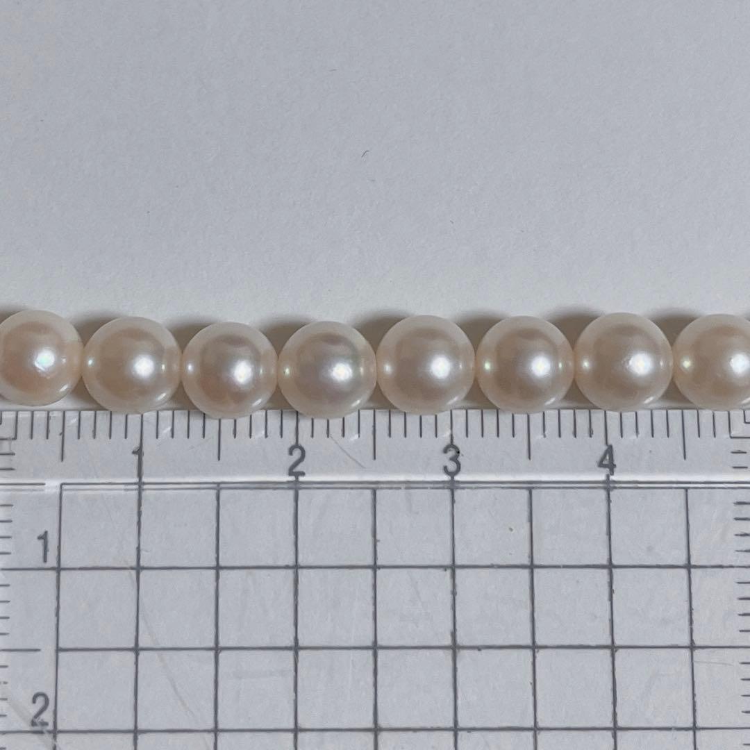 Close-up of 40cm Akoya pearl necklace with 6mm to 6.5mm pearls and silver engraved clasp on white background