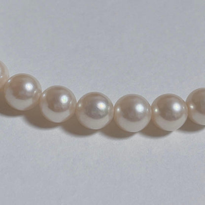 Close-up of 40cm Akoya pearl necklace with 6mm to 6.5mm pearls and silver engraved clasp on white background