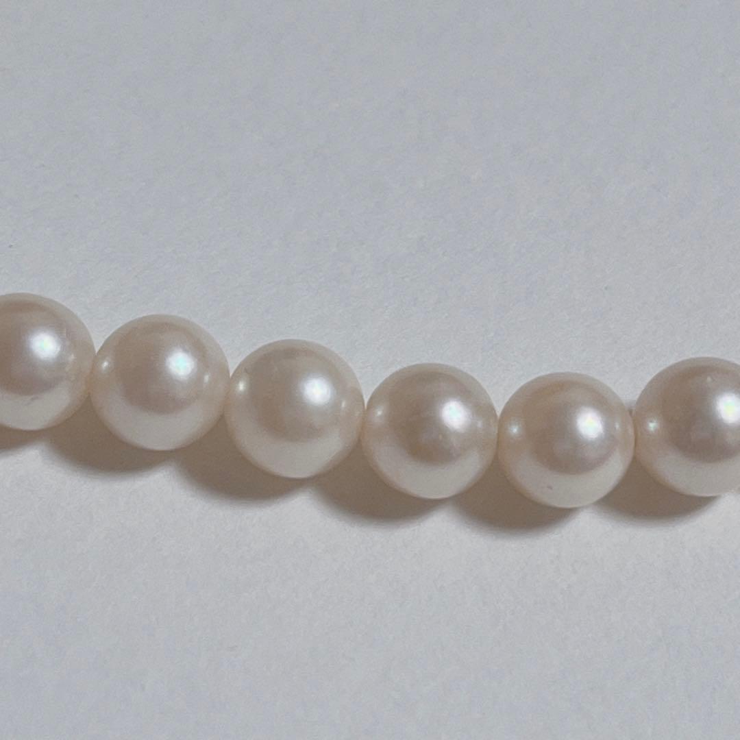 Close-up of 40cm Akoya pearl necklace with 6mm to 6.5mm pearls and silver engraved clasp on white background