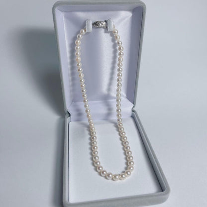 Close-up of 40cm Akoya pearl necklace with 6mm to 6.5mm pearls and silver engraved clasp on white background