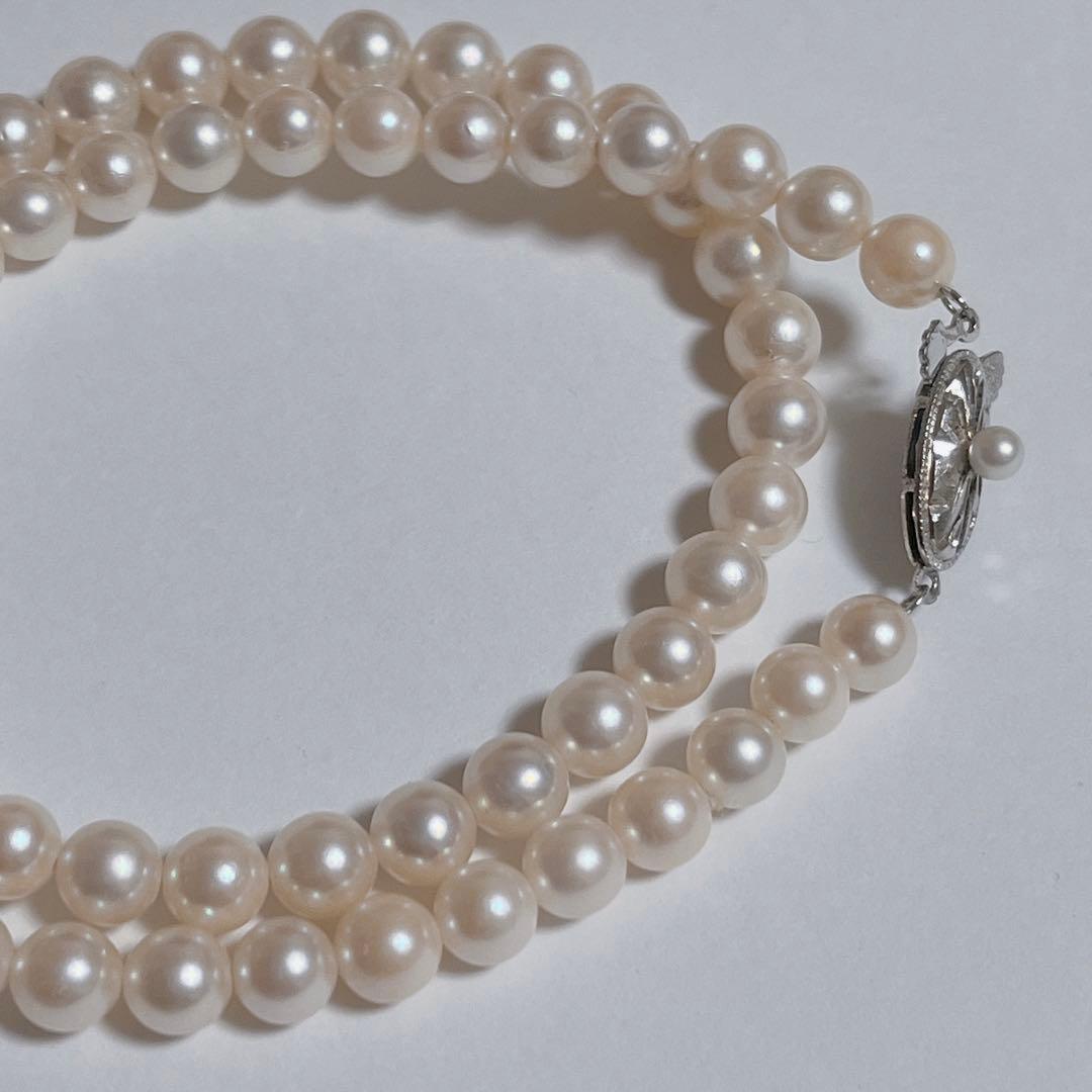 Close-up of 40cm Akoya pearl necklace with 6mm to 6.5mm pearls and silver engraved clasp on white background