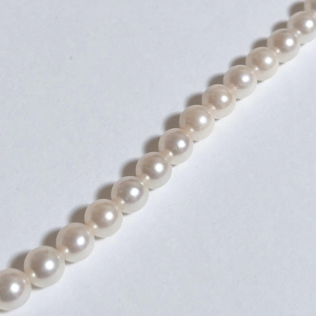 Close-up of 40cm Akoya pearl necklace with 6mm to 6.5mm pearls and silver engraved clasp on white background