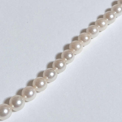 Close-up of 40cm Akoya pearl necklace with 6mm to 6.5mm pearls and silver engraved clasp on white background