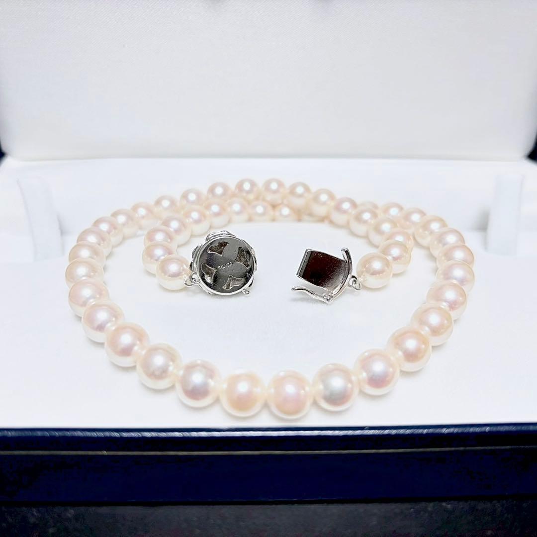 Honka Pearl Akoya necklace with 8.0-8.5mm white pearls and silver clasp on a white background