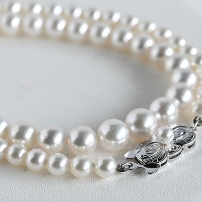 Aurora Hanadama Mikimoto Akoya pearl necklace with round pearls 7.5-5.0 mm and silver clasp on 40 cm string
