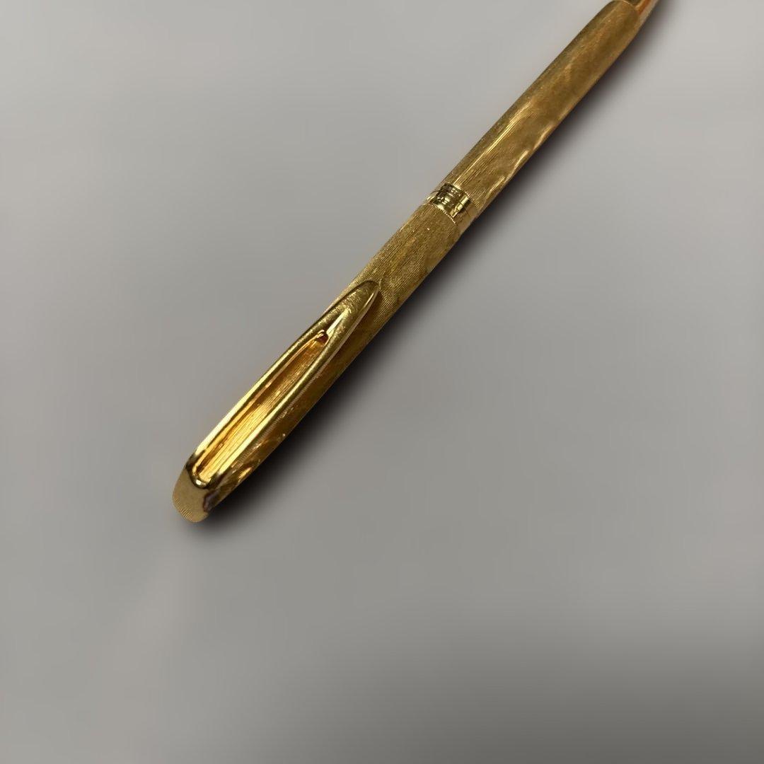 Waterman gold color ballpoint pen with sleek design and smooth finish